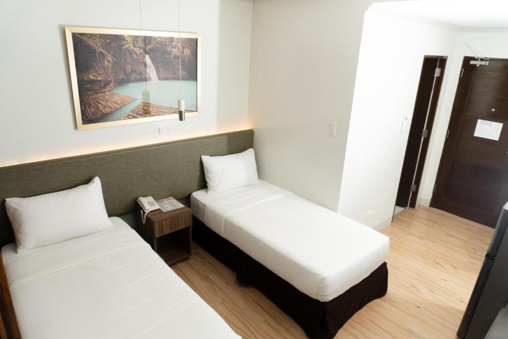 Postel nebo postele na pokoji v ubytování Madison Suites