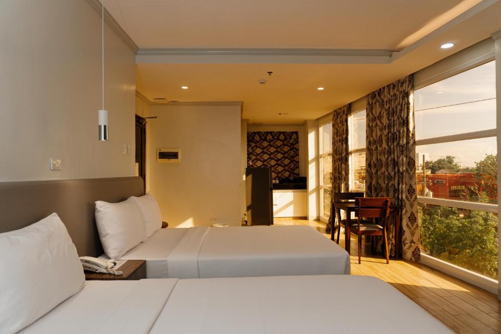 Postel nebo postele na pokoji v ubytování Madison Suites