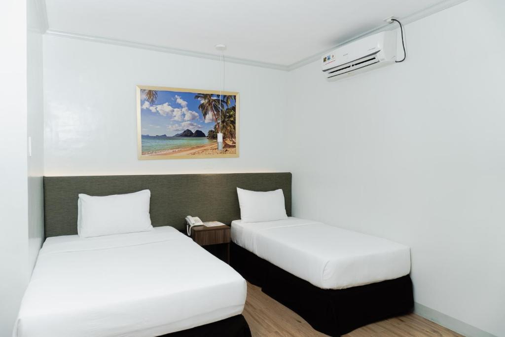 Postel nebo postele na pokoji v ubytování Madison Suites
