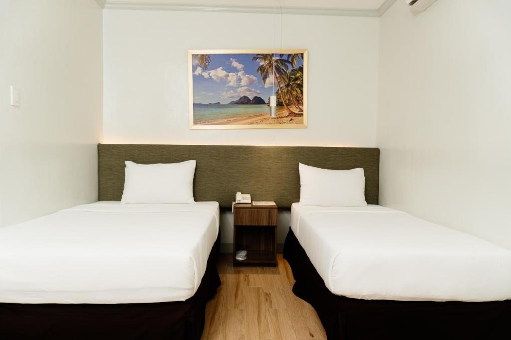 Postel nebo postele na pokoji v ubytování Madison Suites