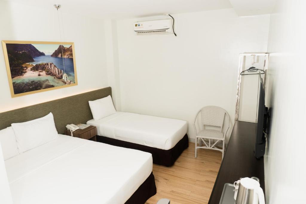 Postel nebo postele na pokoji v ubytování Madison Suites