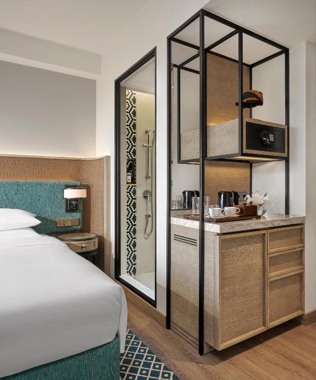 a hotel room with a bed and a bathroom at Hyatt Regency Yogyakarta in Yogyakarta