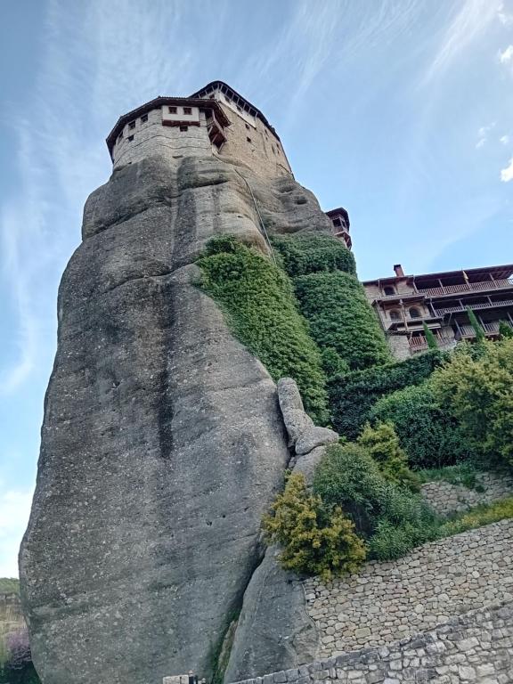 a castle on top of a rock with plants at Meteora best view villa in Kalabaka