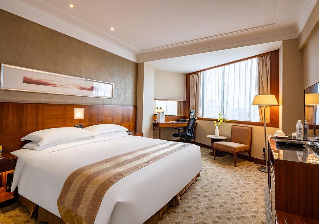 Postel nebo postele na pokoji v ubytování San Want Hotel Shanghai