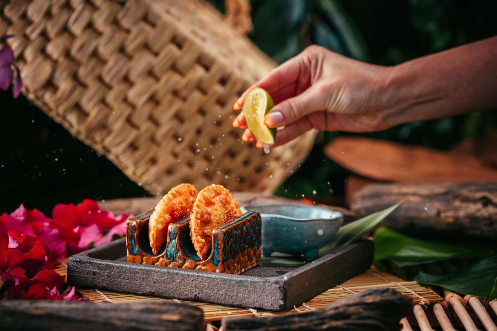a person is cooking food on a grill at Conrad Abu Dhabi Etihad Towers in Abu Dhabi