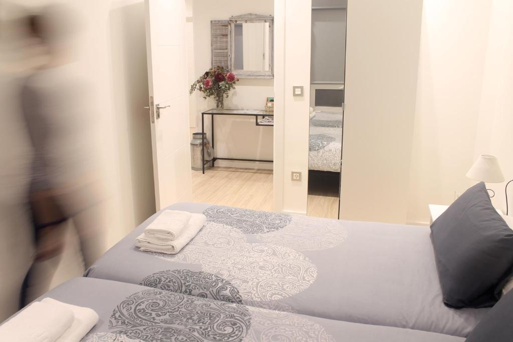 - une chambre avec un lit et des serviettes dans l'établissement Talaia HT, à Saint-Sébastien