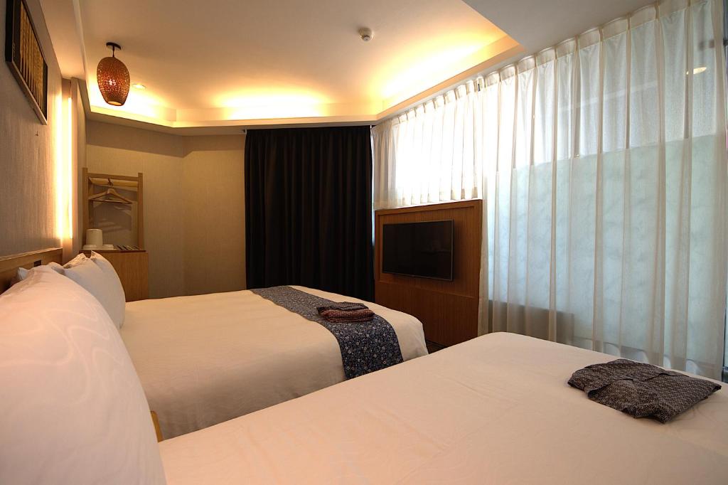 Postel nebo postele na pokoji v ubytování Tenlien onsen Hot Spring Hotel