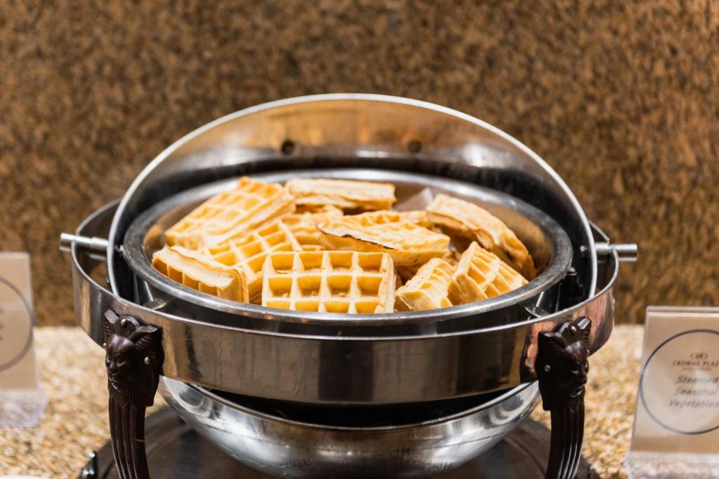 a pan filled with waffles sitting on a table at Crowne Plaza Newark Airport by IHG in Elizabeth