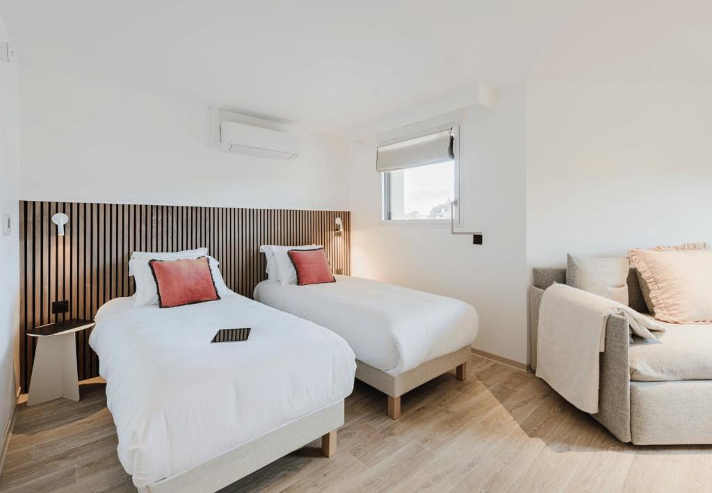 Postel nebo postele na pokoji v ubytování Appart Hotel Neostelia