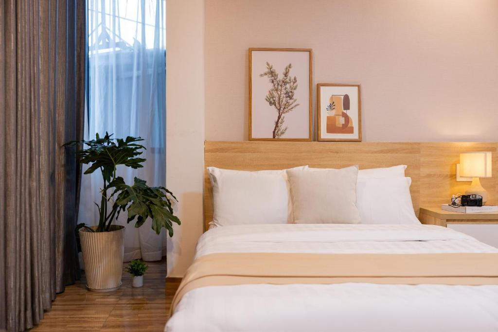 Postel nebo postele na pokoji v ubytování Phương Trinh Hotel