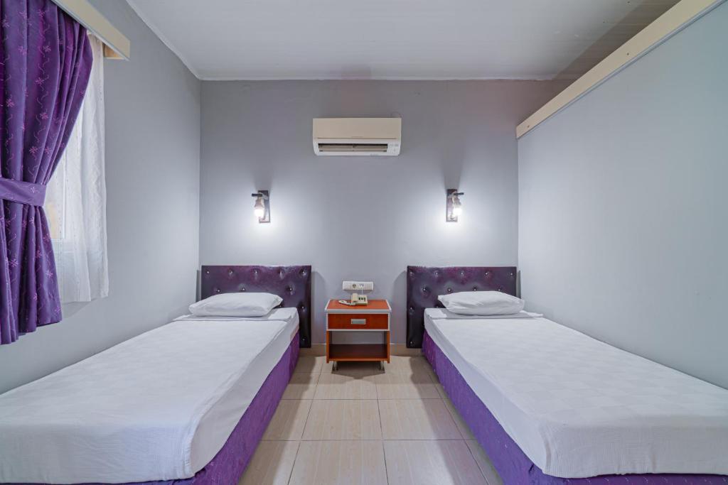 Postel nebo postele na pokoji v ubytování Sayanora Hotel