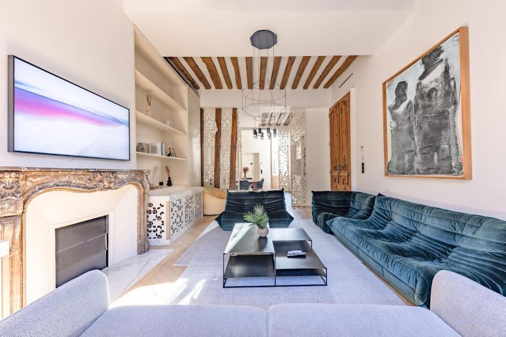 un salon avec un canapé et une cheminée dans l'établissement Chic 2-Bedroom Haven, à Paris
