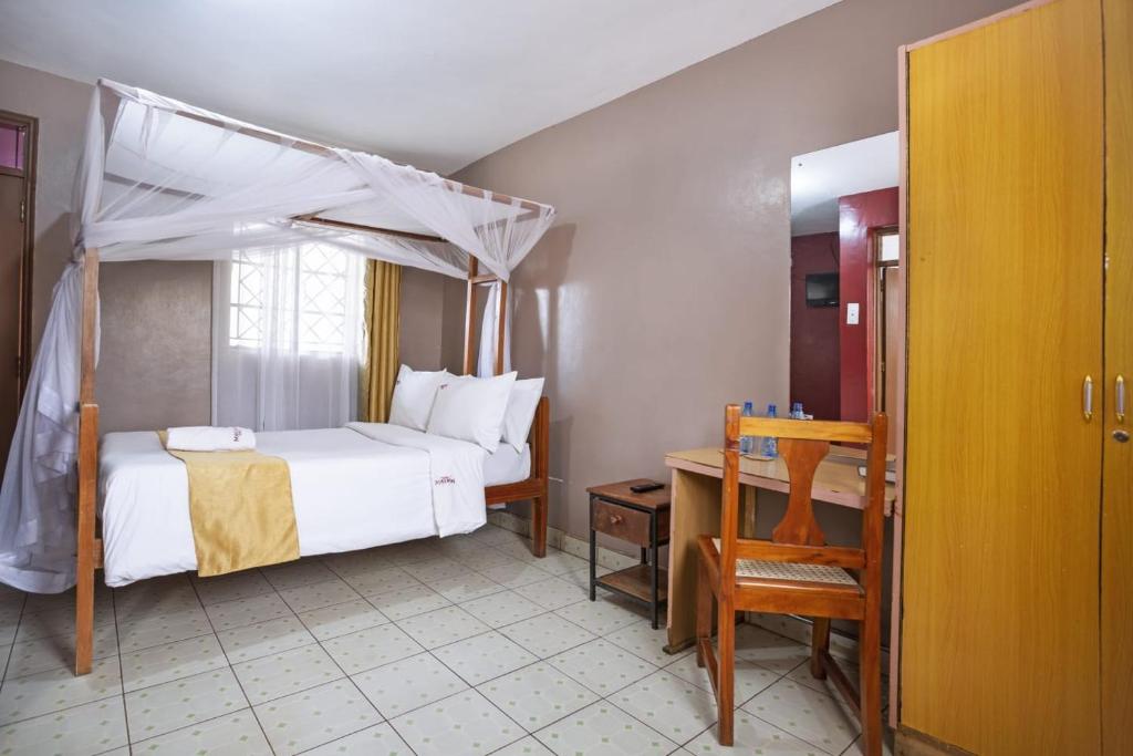 Postel nebo postele na pokoji v ubytování Melvic Hotel