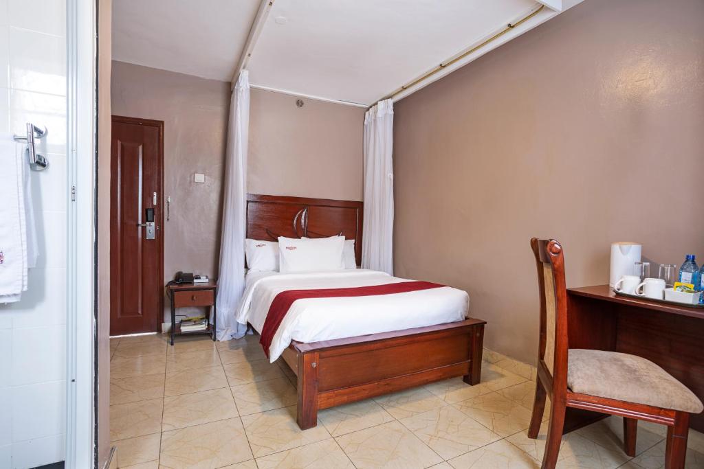 Postel nebo postele na pokoji v ubytování Melvic Hotel