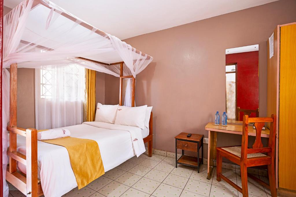 Postel nebo postele na pokoji v ubytování Melvic Hotel