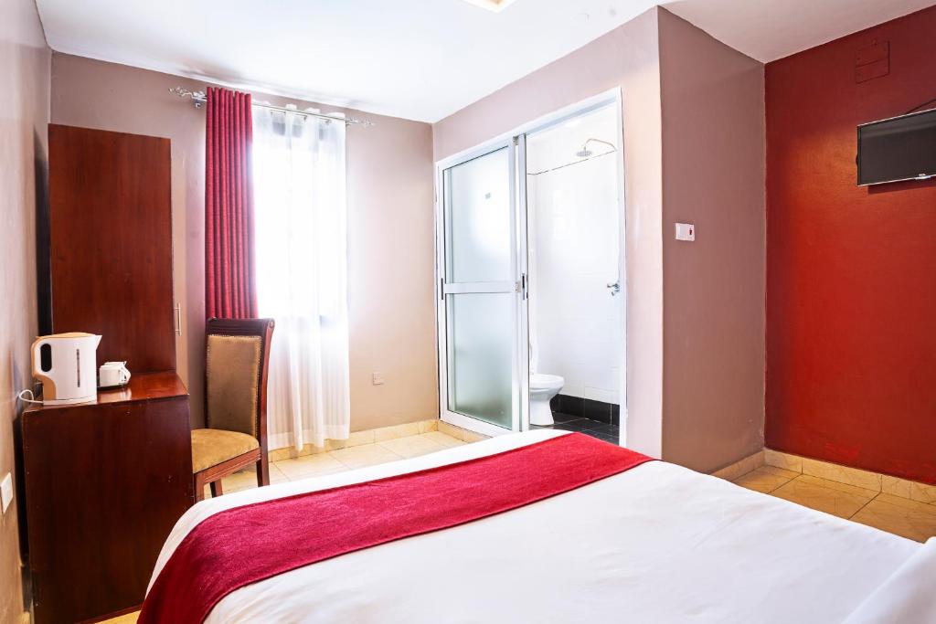 Postel nebo postele na pokoji v ubytování Melvic Hotel