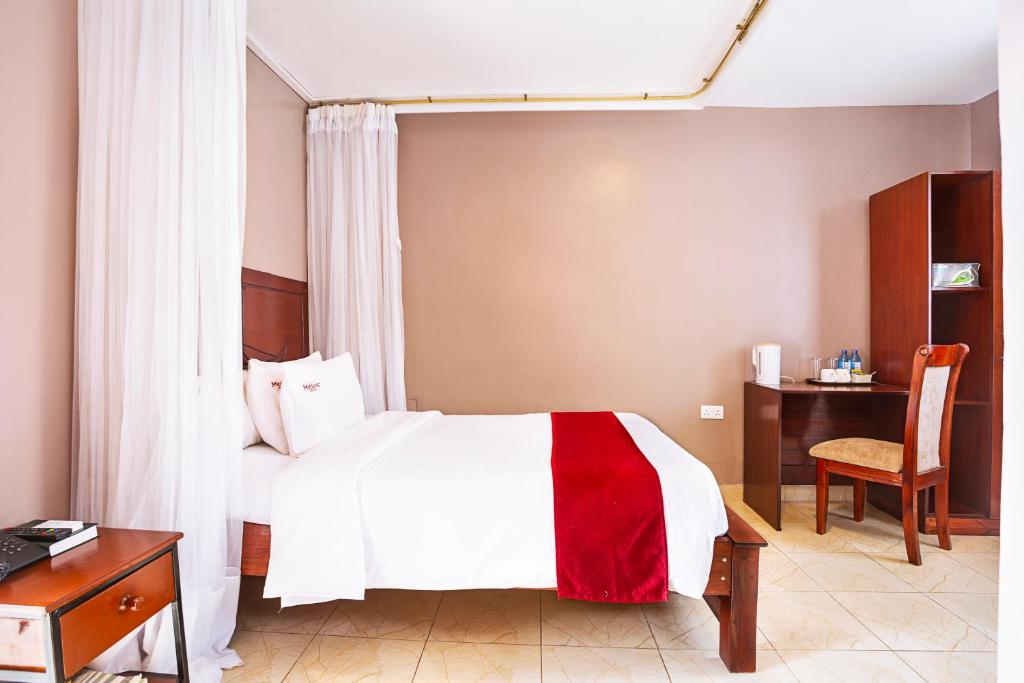 Postel nebo postele na pokoji v ubytování Melvic Hotel