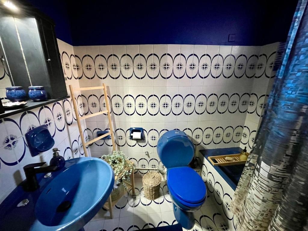 a bathroom with a blue toilet and a sink at ID Home in Ioannina