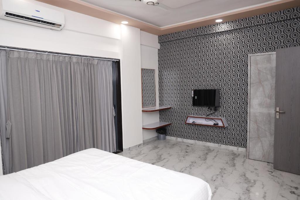 Postel nebo postele na pokoji v ubytování Hotel Sahara Residency