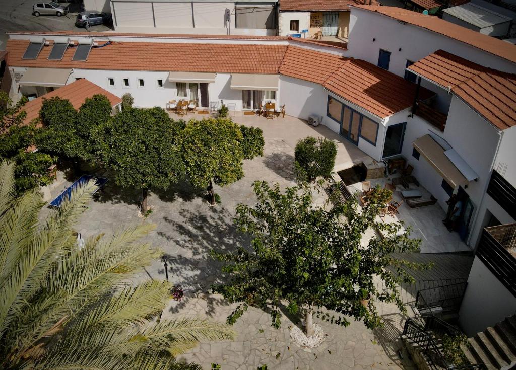 an overhead view of a house with a courtyard and trees at The Courtyard Episkopi Guest Houses in Episkopi Limassol