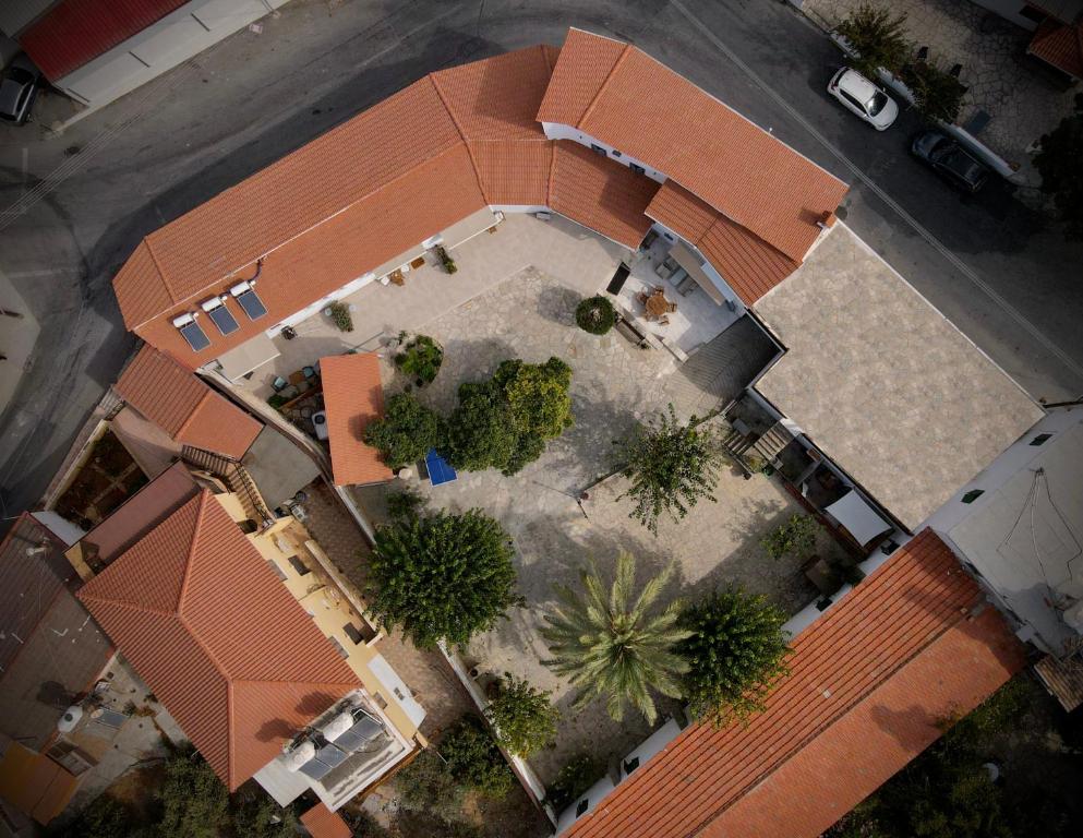 an overhead view of a building with a courtyard with trees at The Courtyard Episkopi Guest Houses in Episkopi Limassol