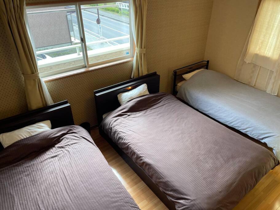 Postel nebo postele na pokoji v ubytování GuestHouse　YOU&I