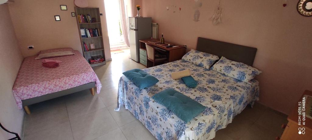 a bedroom with a bed with pillows on it at Il giardino del Sole in Galatone