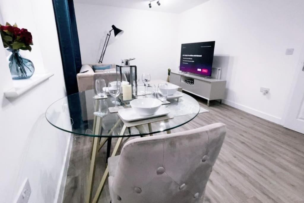 a glass table and a chair in a living room at Fabulous 2bedroom flat in Coventry