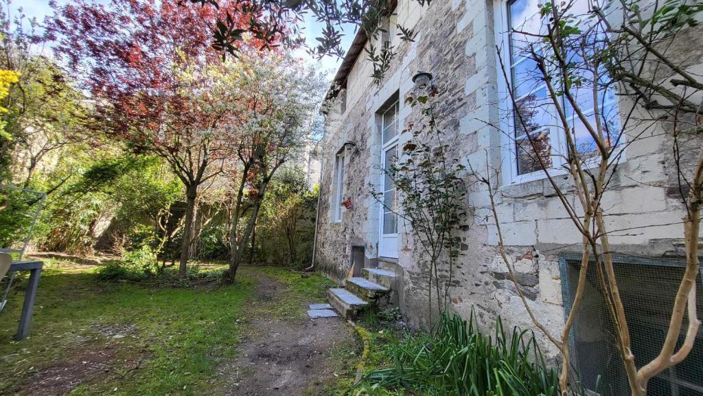 a stone building with a bench next to a building at Loire and Baluchon in Ancenis