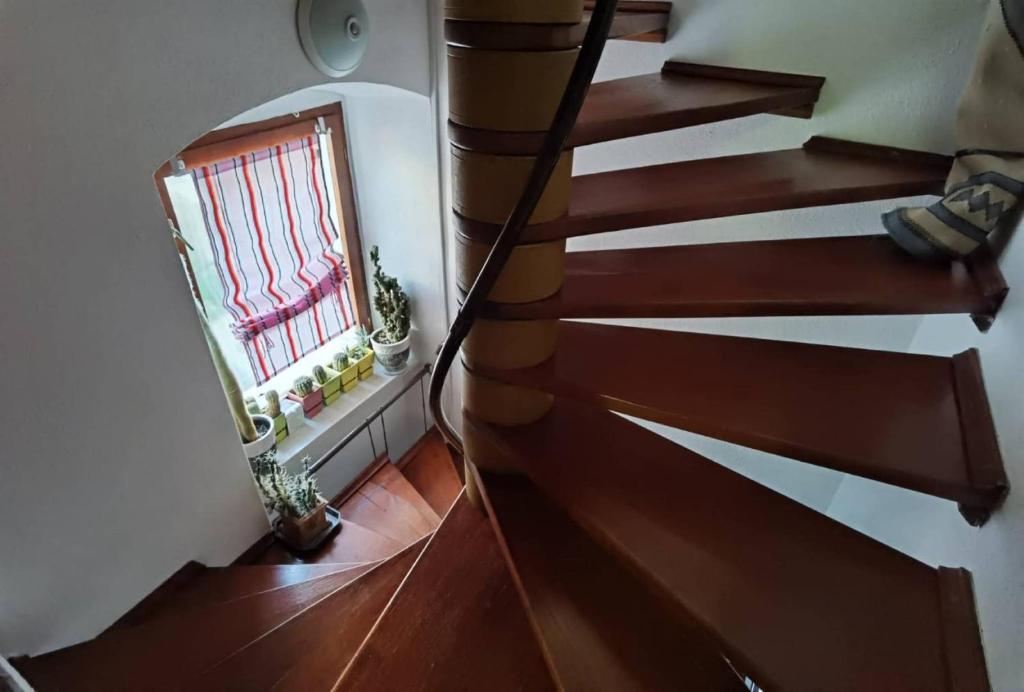 an overhead view of a wooden staircase with a window at Cozy Studio Apartments with Terrace Near Kaštela Promenade in Kaštela