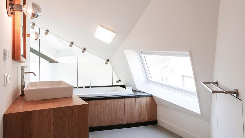 a bathroom with a sink and a window at Dutchen Park Duynzoom in De Koog