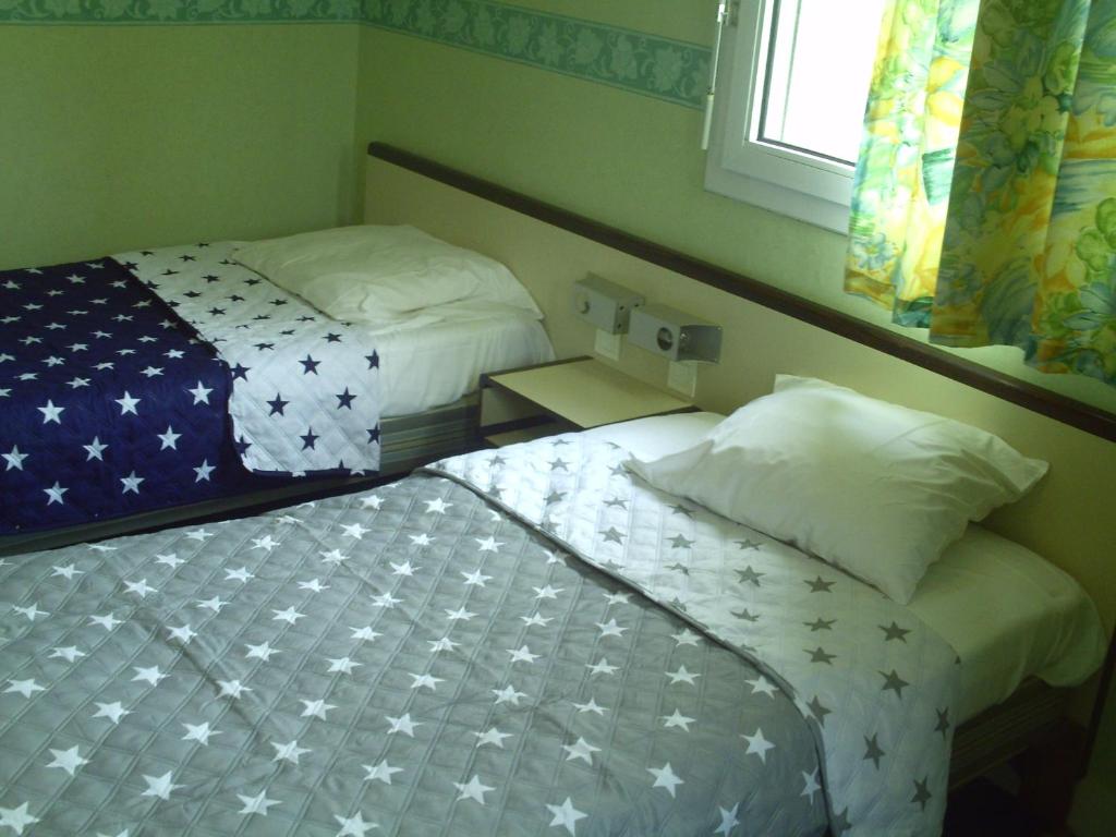 Postel nebo postele na pokoji v ubytování Hôtel l'Eden