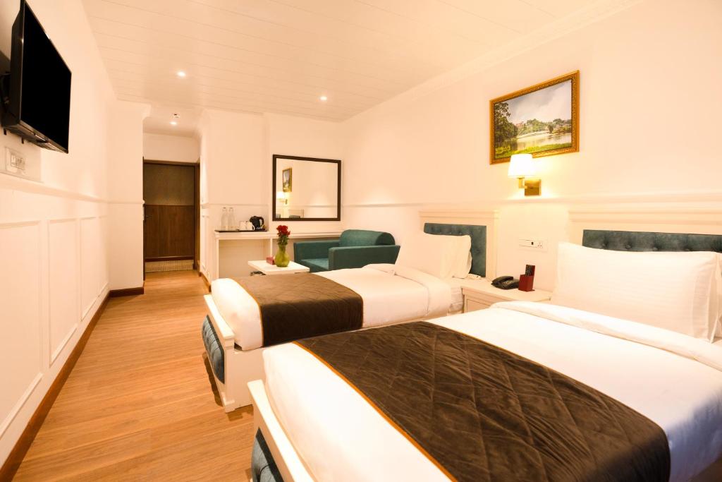 Postel nebo postele na pokoji v ubytování Summit Mall Stone Hotel