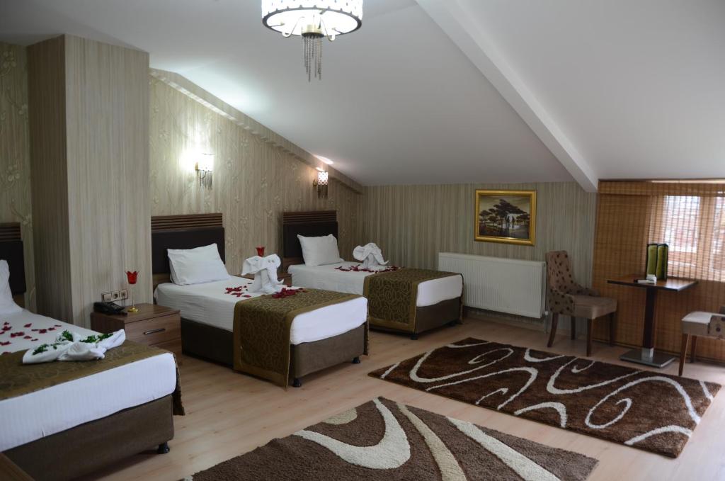 Krevet ili kreveti u jedinici u okviru objekta Gumus Palace Hotel