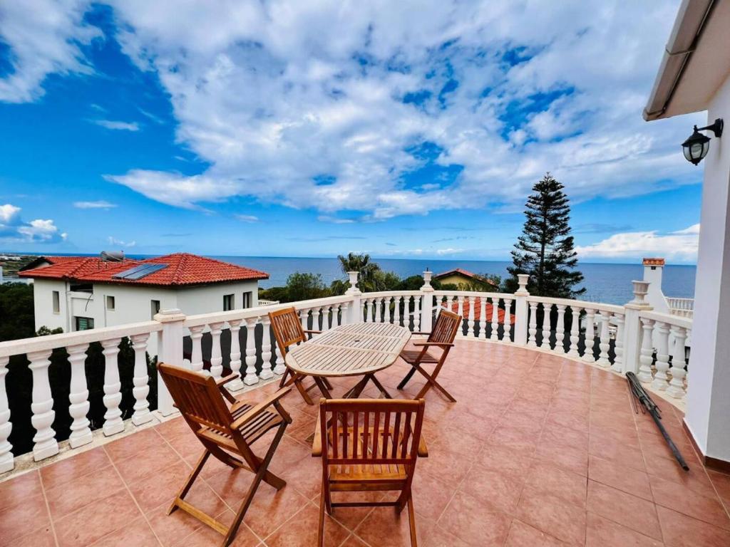 a patio with a table and chairs on a balcony at Villa Rosa by HolidayKeys in Kyrenia