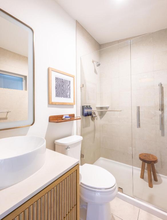 a bathroom with a sink and a toilet and a shower at Islander Resort in Islamorada