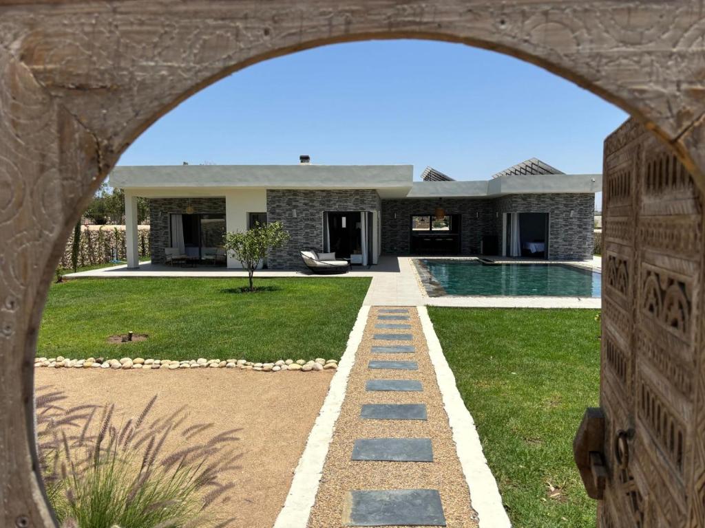 an external view of a house with a swimming pool at DAR PITXI - Personnel inclu in Essaouira