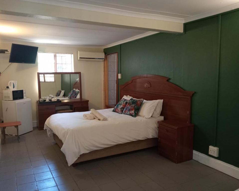 Postel nebo postele na pokoji v ubytování Villa de la Rosa Klerksdorp