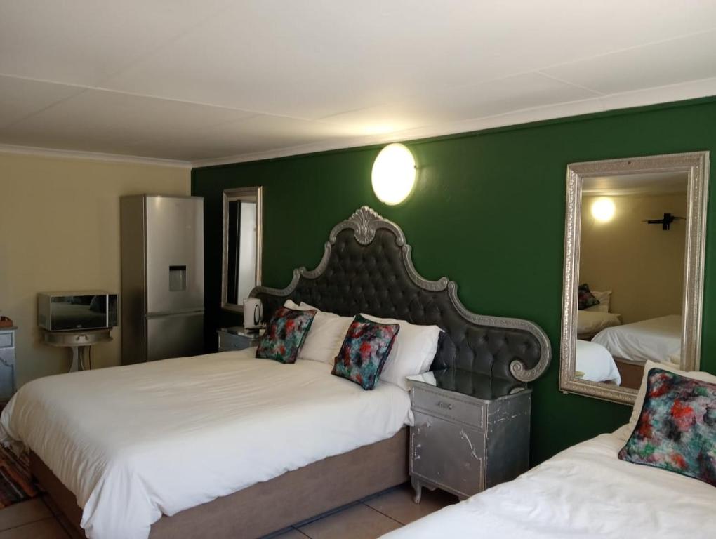 Postel nebo postele na pokoji v ubytování Villa de la Rosa Klerksdorp