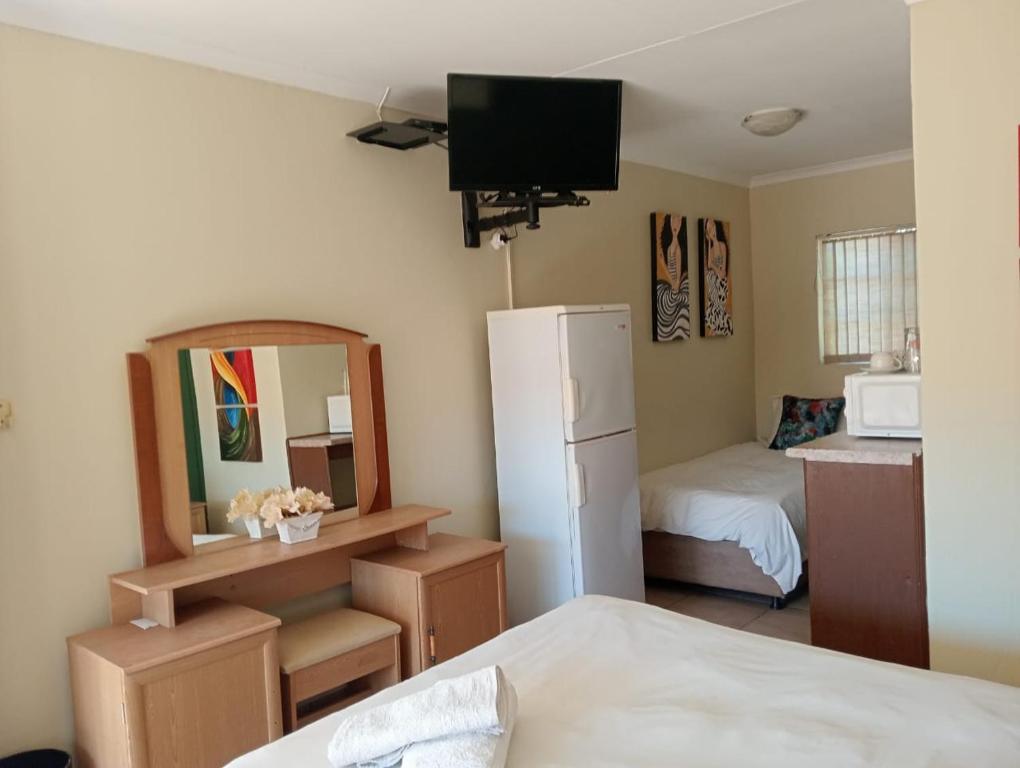 Postel nebo postele na pokoji v ubytování Villa de la Rosa Klerksdorp