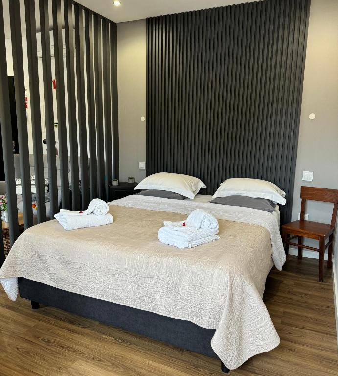 two beds with towels on them in a bedroom at O Cantinho do Colégio - Dourocollege in Lamego