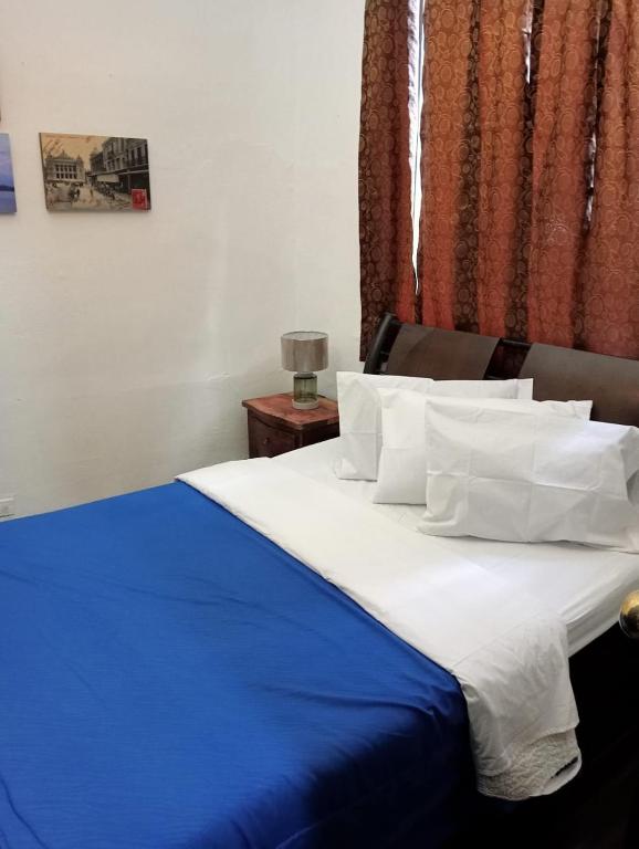 Postel nebo postele na pokoji v ubytování Hostal Hanoi en Bogotá