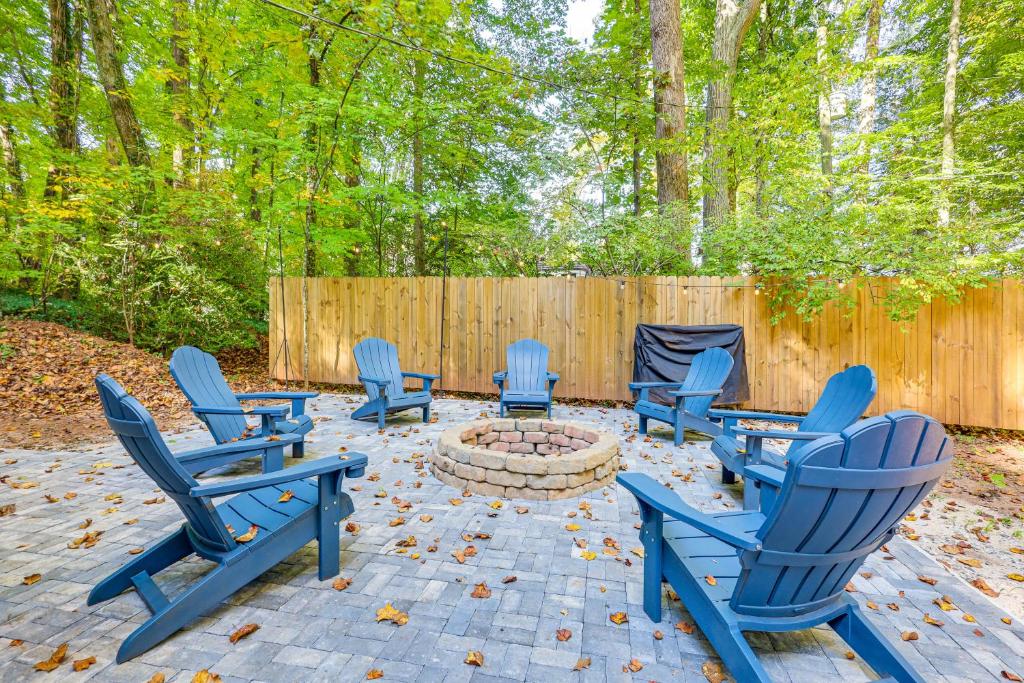 a patio with blue chairs and a fire pit at Family-Friendly Knoxville Home Close to UT! in Knoxville