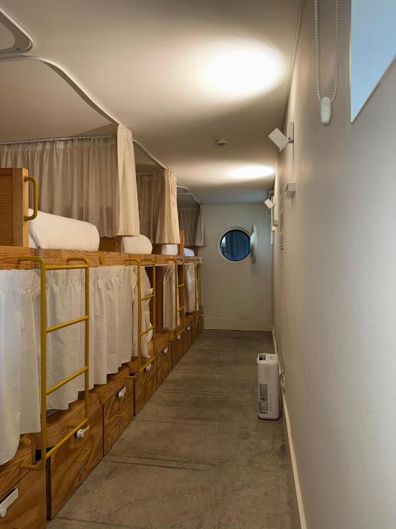 a hallway of a dorm room with a bed at Surf & Sea Suites in Parede