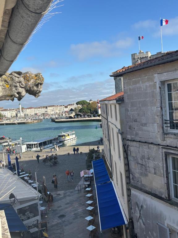 - une vue sur la plage depuis un bâtiment doté d'une rampe bleue dans l'établissement Appartement 3 pièces sur le Vieux Port, plein centre, à La Rochelle