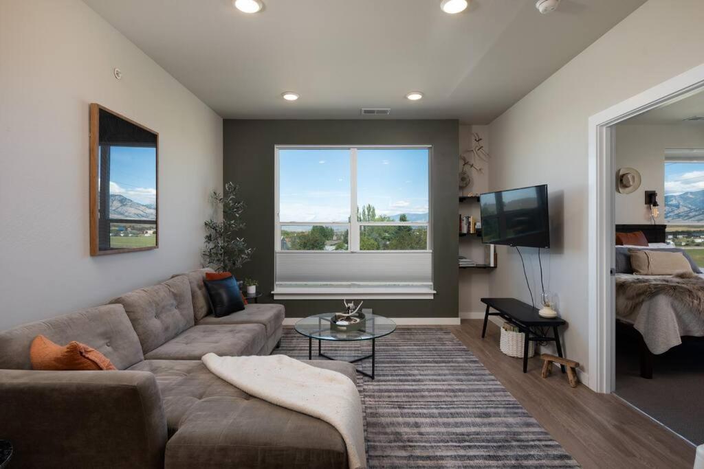 a living room with a couch and a television at Cinnabar Suite - Mountain Views in Bozeman