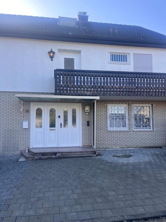 a brick house with white doors and a patio at Villa Altdorf in Ettenheim