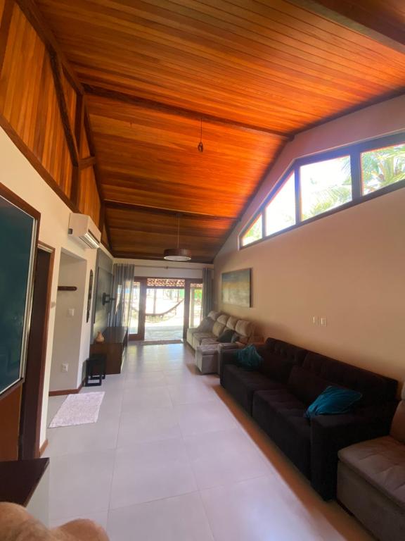 a living room with a couch and a tv at Casa Portas do Mar in Marau