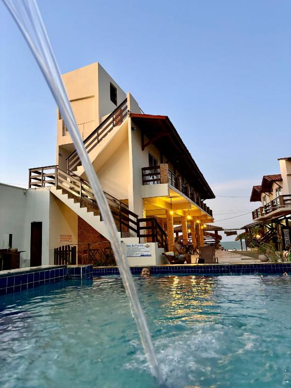 a water fountain in front of a building at Pousada e Restaurante Altas Horas Beach in Itapipoca