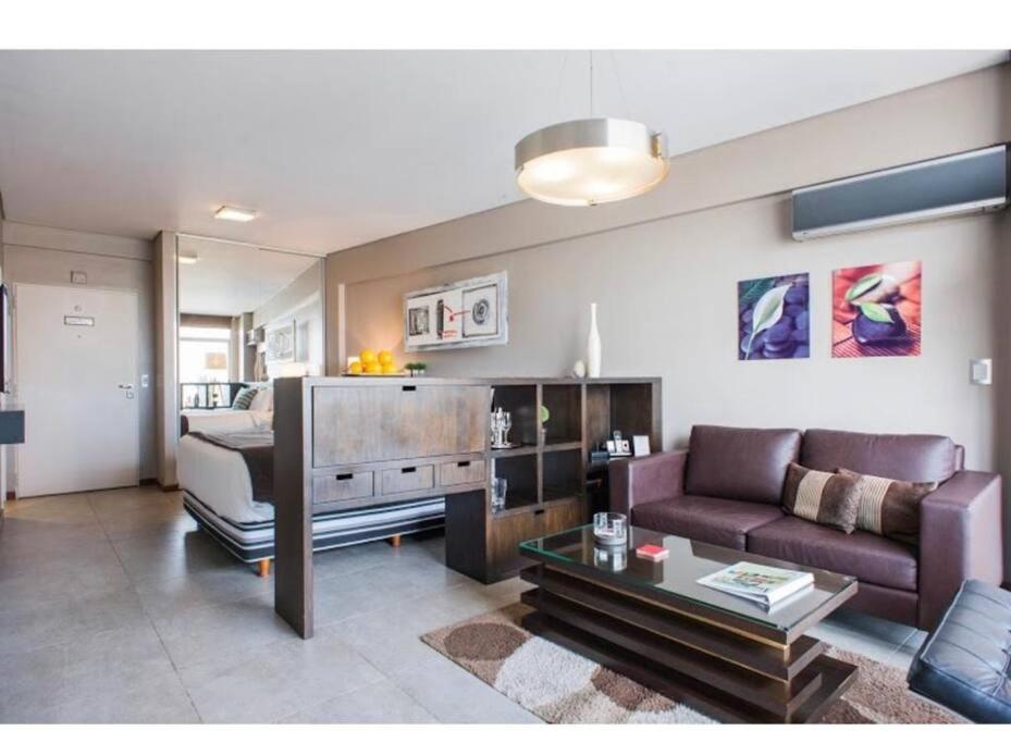 a living room with a couch and a table at Recoleta - Elite 13th floor apt with rooftop pool in Buenos Aires